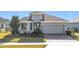 Gray one-story house with a landscaped front yard and a brick driveway at 17863 Passionflower Cir, Clermont, FL 34714