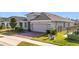 Gray house with two-car garage and landscaped yard at 17863 Passionflower Cir, Clermont, FL 34714