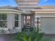 Gray house with a welcoming front porch at 17863 Passionflower Cir, Clermont, FL 34714