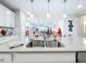 Kitchen island with a stainless steel sink and modern light fixtures at 17863 Passionflower Cir, Clermont, FL 34714