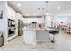 Modern kitchen with white cabinets, a large island, and stainless steel appliances at 17863 Passionflower Cir, Clermont, FL 34714