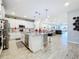Open concept kitchen with white cabinets and stainless steel appliances at 17863 Passionflower Cir, Clermont, FL 34714