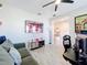 Living area with a large TV and a view of the dining area at 17863 Passionflower Cir, Clermont, FL 34714