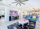 Living room with fireplace and large TV at 17863 Passionflower Cir, Clermont, FL 34714