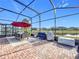 Outdoor patio with seating area, grill, and covered lanai at 17863 Passionflower Cir, Clermont, FL 34714