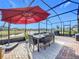 Enjoy dining alfresco under the covered patio with lake views! at 17863 Passionflower Cir, Clermont, FL 34714