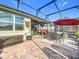 Spacious screened patio with dining and lounge areas at 17863 Passionflower Cir, Clermont, FL 34714