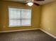 Spacious bedroom with window and neutral walls at 2007 Dixie Belle Dr # 2007 I, Orlando, FL 32812