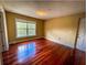 Bright bedroom with hardwood floors and large window at 2007 Dixie Belle Dr # 2007 I, Orlando, FL 32812