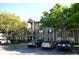 Exterior view of a multi-story apartment building with mature trees and visible parking at 2007 Dixie Belle Dr # 2007 I, Orlando, FL 32812