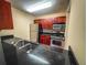 Kitchen with dark wood cabinets, granite counters and stainless appliances at 2007 Dixie Belle Dr # 2007 I, Orlando, FL 32812