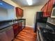 Kitchen with stainless steel appliances and dark wood cabinets at 2007 Dixie Belle Dr # 2007 I, Orlando, FL 32812