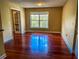 Hardwood floor living room with french doors and large window at 2007 Dixie Belle Dr # 2007 I, Orlando, FL 32812