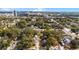 Stunning aerial shot showcasing the property among a vibrant neighborhood with lush trees and the city in the distance at 2223 Amherst Ave, Orlando, FL 32804