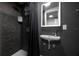 This remodeled bathroom features a small sink, LED mirror and tiled walk-in shower at 2223 Amherst Ave, Orlando, FL 32804