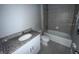 Bathroom with granite countertop, a bathtub, and tiled floors at 231 Tarpon Bay Blvd, Haines City, FL 33844