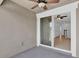 Relaxing covered balcony with ceiling fan and slider to the interior at 2617 Amati Dr, Kissimmee, FL 34741