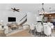 Open-concept living and dining area with modern furnishings, stylish decor, and staircase to upper level at 2617 Amati Dr, Kissimmee, FL 34741