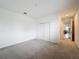 Bedroom with carpet flooring, double door closet, and hallway access at 2821 Rialto Ct, Kissimmee, FL 34746