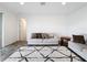 Living room features two sofas, end table, and access to another room at 2821 Rialto Ct, Kissimmee, FL 34746