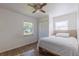 Bright bedroom with double bed, window, and wood-look floors at 2959 Old Dixie Hwy, Kissimmee, FL 34744