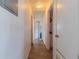 Clean hallway with light wood flooring and access to bedrooms at 2959 Old Dixie Hwy, Kissimmee, FL 34744