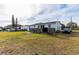 White single-story house with a deck and grassy yard at 2959 Old Dixie Hwy, Kissimmee, FL 34744