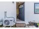 Home exterior with a dark gray door and AC unit at 2959 Old Dixie Hwy, Kissimmee, FL 34744