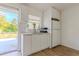 Simple kitchen with white cabinets and a door leading outside at 2959 Old Dixie Hwy, Kissimmee, FL 34744