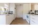 Bright white kitchen features modern appliances and wood-look floors at 2959 Old Dixie Hwy, Kissimmee, FL 34744