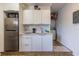Small kitchen with white cabinets and stainless steel fridge at 2959 Old Dixie Hwy, Kissimmee, FL 34744