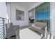 Private balcony with wicker furniture and water views at 3131 Paradox Cir # 401, Kissimmee, FL 34746