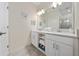 Double vanity bathroom with modern white cabinets at 3131 Paradox Cir # 401, Kissimmee, FL 34746