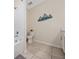 Bathroom with toilet, tub, and nautical decor at 3131 Paradox Cir # 401, Kissimmee, FL 34746