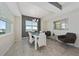Bright dining room with modern white table and chairs, offering city views at 3131 Paradox Cir # 401, Kissimmee, FL 34746