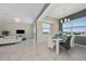 Bright dining area with white table and chairs, overlooking a lake at 3131 Paradox Cir # 401, Kissimmee, FL 34746