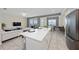 Open concept living area with white sofa and access to a balcony at 3131 Paradox Cir # 401, Kissimmee, FL 34746