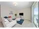 Living room with white sectional sofa and access to balcony at 3131 Paradox Cir # 401, Kissimmee, FL 34746