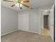 Cozy bedroom with carpet, ceiling fan, and access to bathroom at 33 W Country Cove Way, Kissimmee, FL 34743