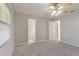 Serene bedroom with carpet flooring, ceiling fan, and ample closet space at 33 W Country Cove Way, Kissimmee, FL 34743