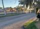 Community entrance with a black metal fence and palm trees at 33 W Country Cove Way, Kissimmee, FL 34743