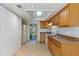 Functional kitchen featuring wood cabinets, tile floor, and modern appliances at 33 W Country Cove Way, Kissimmee, FL 34743