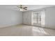 Bright living room featuring tile flooring, ceiling fan, and a large window with natural light at 33 W Country Cove Way, Kissimmee, FL 34743