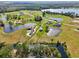 Aerial view of a waterfront community with multiple homes and lakes at 3412 Lake Diane Rd, Tavares, FL 32778
