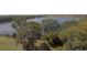 Property with lake access, lush vegetation, and a dock at 3412 Lake Diane Rd, Tavares, FL 32778