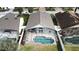 Aerial view of house with pool and screened enclosure at 507 Cassia Dr, Davenport, FL 33897
