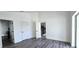 Bedroom with wood-look floors and access to bathroom and kitchen at 507 Cassia Dr, Davenport, FL 33897
