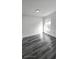 Bright bedroom with grey vinyl flooring and a large window at 507 Cassia Dr, Davenport, FL 33897