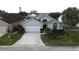 Two-story house with gray exterior, white garage door, and landscaping at 507 Cassia Dr, Davenport, FL 33897