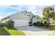 Single-story home with a white garage door and landscaping at 507 Cassia Dr, Davenport, FL 33897